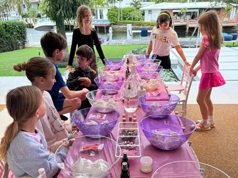 Kids making slime at a long outdoor party table