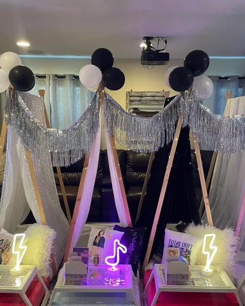Teen sleepover with silver tinsel teepees and black and white balloons