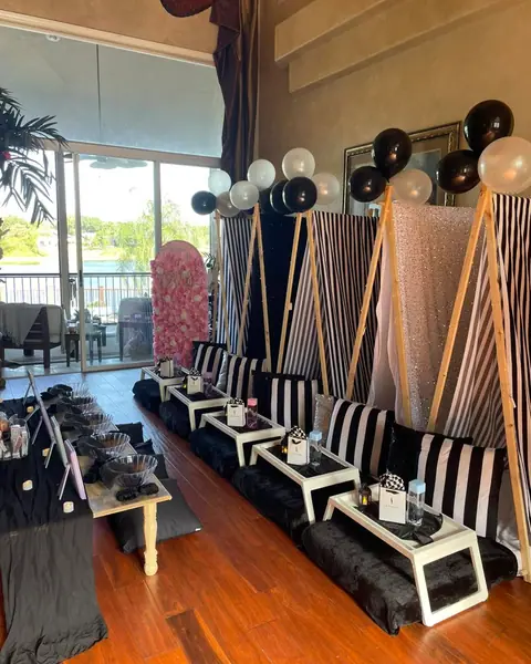 Black and white striped sleepover setup with balloons by the window