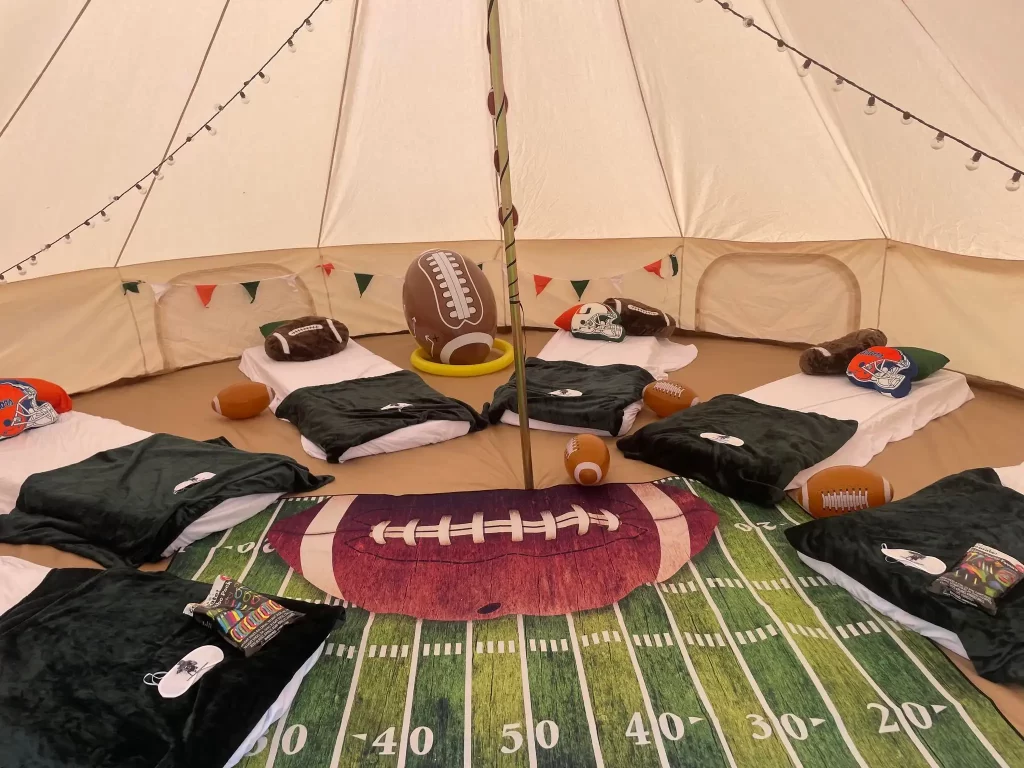 A Ultimate Movie Night Setup Training Package - Transform Your Events filled with football pillows and blankets.